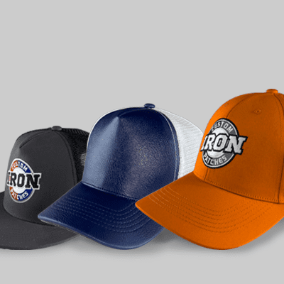 Orange and gray custom trucker hat placed on a rock.